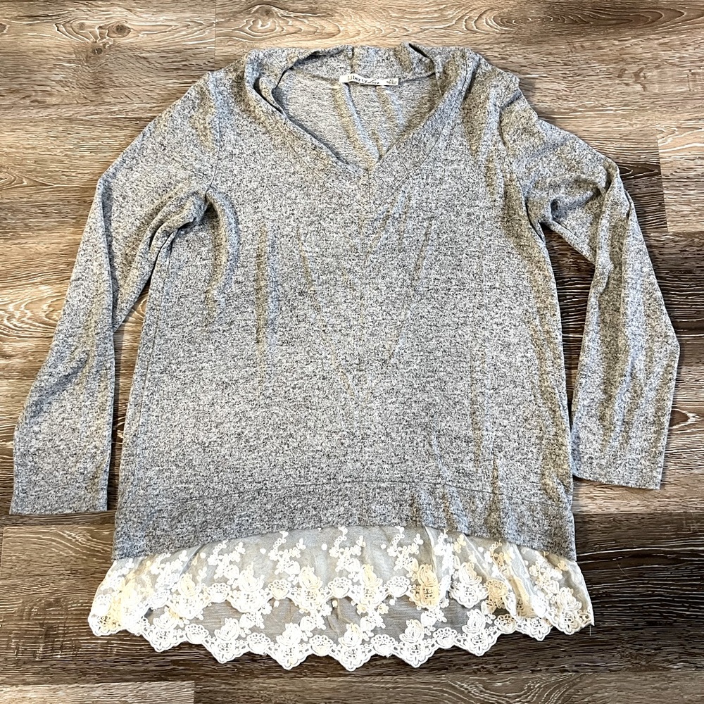 Elegant Sweater with Lace Detail bottom.
